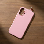 digitaley.co pink silicone phone case with a slim-waist tea glass motif on a wooden background.