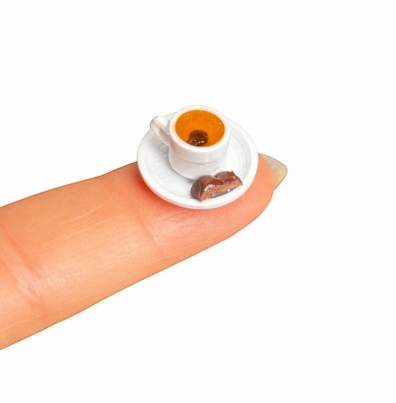 digitaley.co 3D miniature Turkish coffee cup and chocolate on a white saucer, realistic detail.