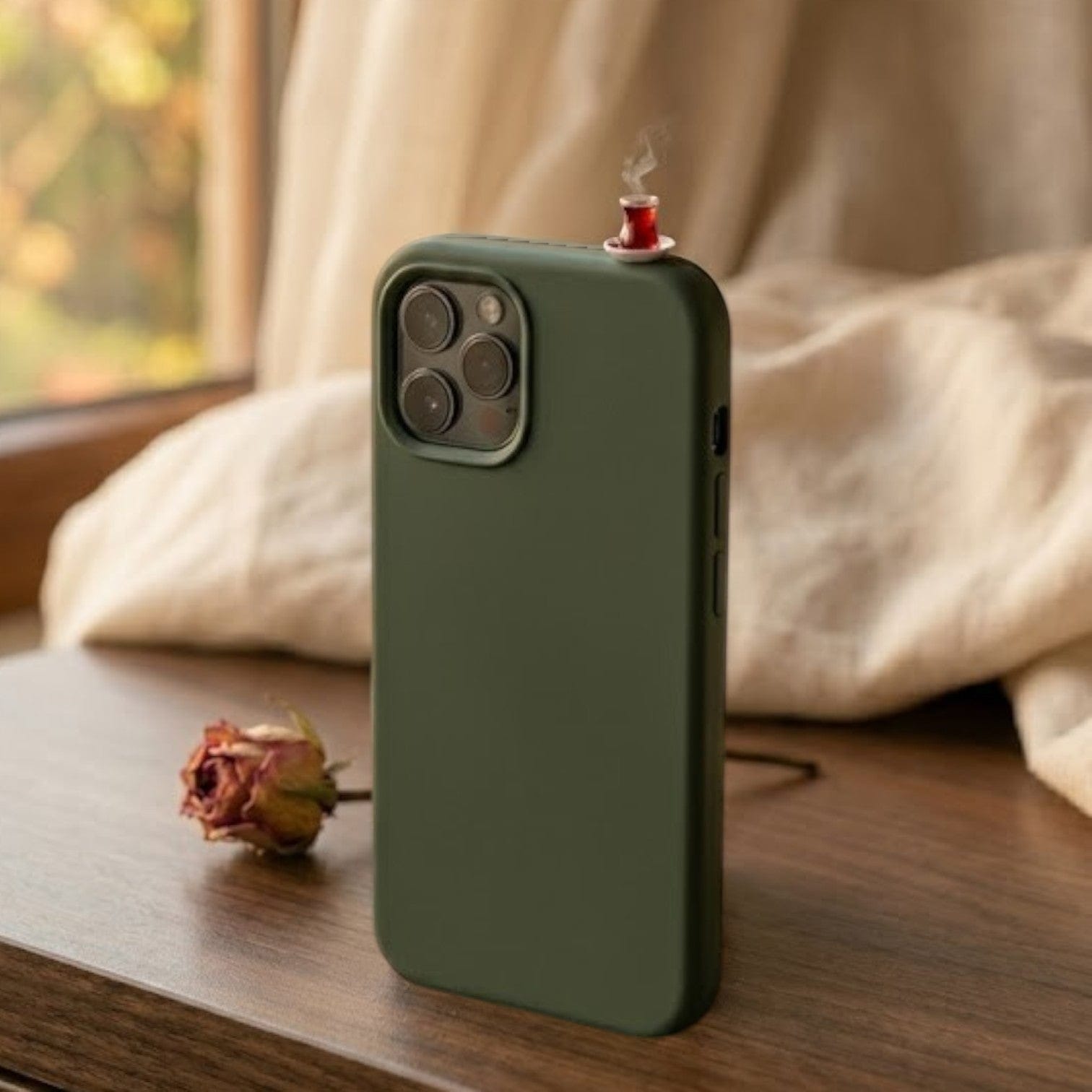 digitaley.co dark green silicone iPhone case with a miniature tea glass motif on top. Features a slim-waist design.