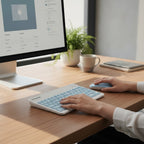 digitaley.co pastel blue wireless keyboard and mouse set with quiet keys and ergonomic design on a wooden desk.